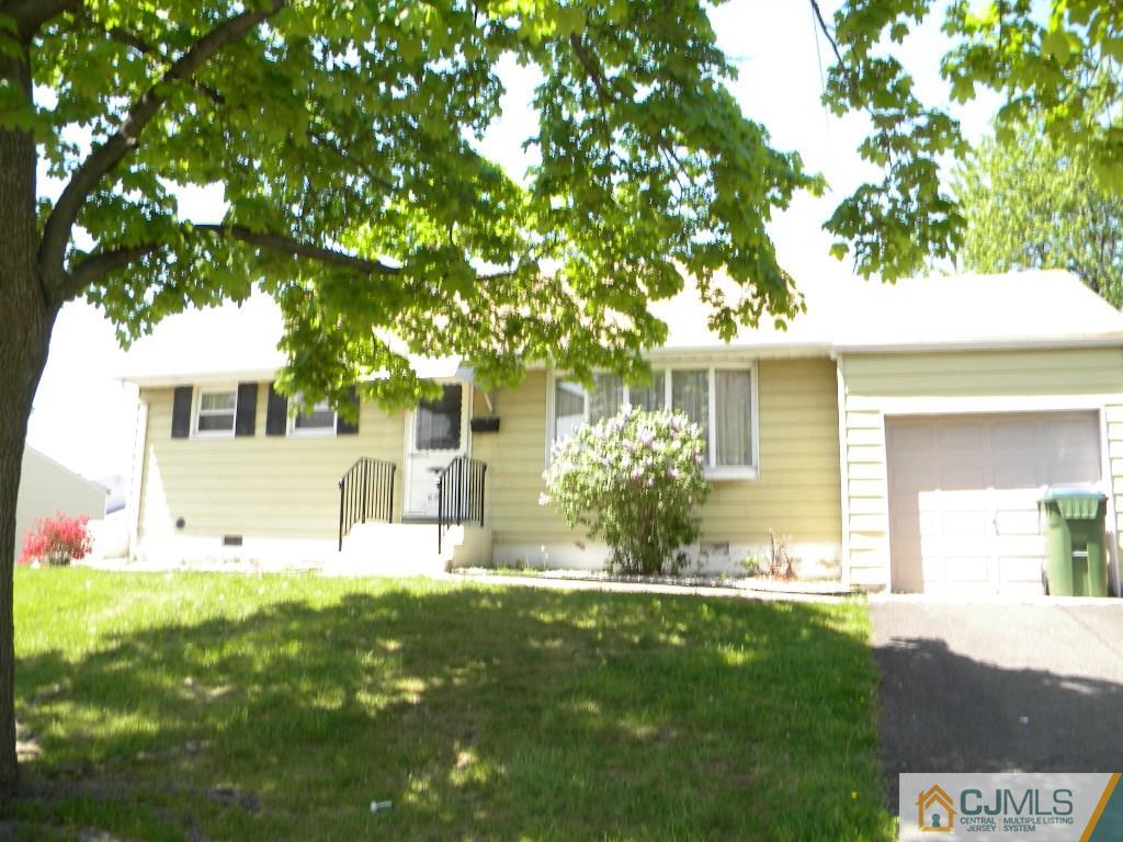 69 Eardley Road Edison, NJ 08817 - Photo 1 of 13 a front view of a house with a yard and a tree