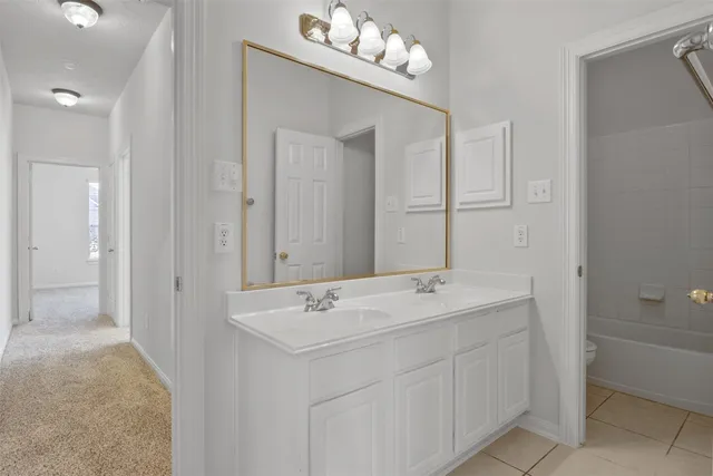 a bathroom with a sink a mirror and a shower