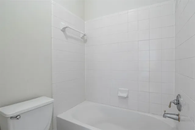 a bathroom with a bathtub and toilet