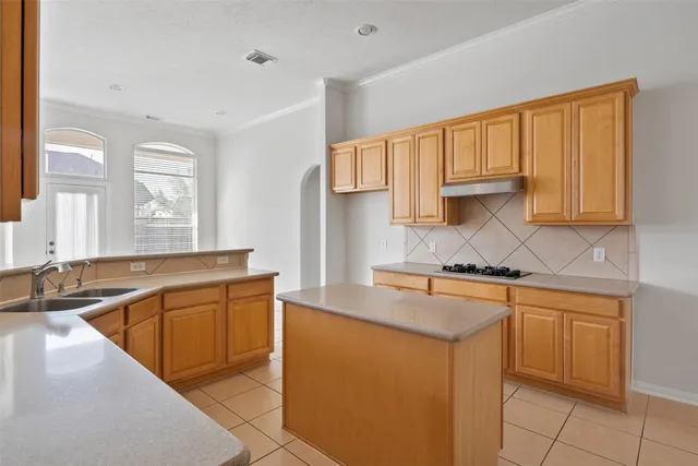 a kitchen with stainless steel appliances granite countertop a sink stove and cabinets
