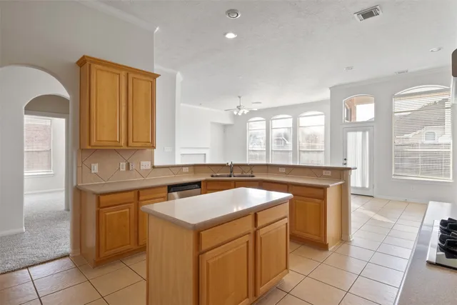 a kitchen with a sink cabinets and window