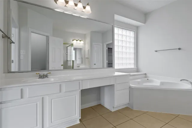 a bathroom with a sink vanity and mirror