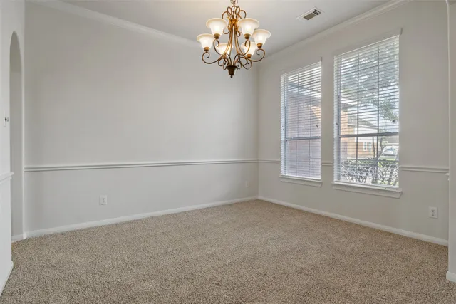 a view of a chandelier in big room and chandelier