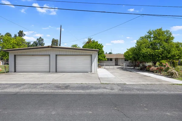 a front view of a house with a yard and a garage