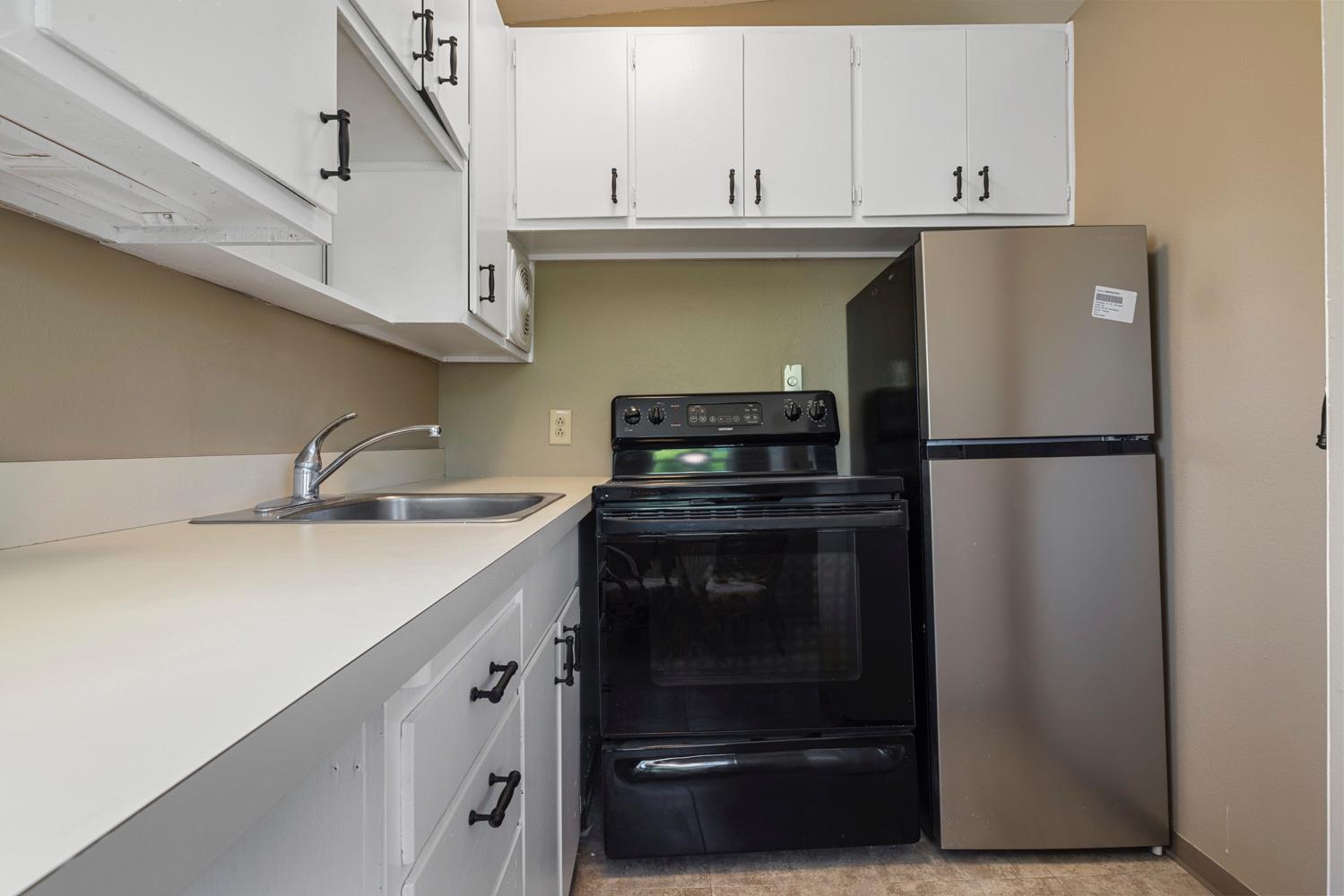 3824 Hubbard Road Stockton, CA 95215 - Photo 27 of 79 a kitchen with stainless steel appliances a refrigerator sink and cabinets