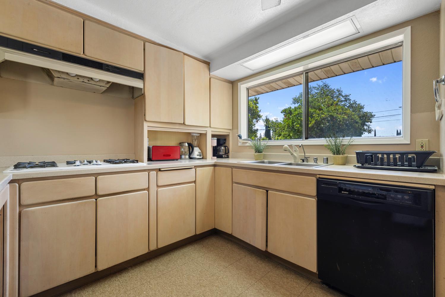 3824 Hubbard Road Stockton, CA 95215 - Photo 35 of 79 a kitchen with sink cabinets and wooden floor