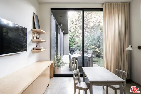 a kitchen with a table chairs and refrigerator
