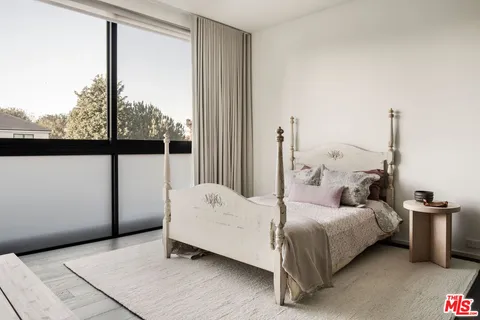 a bed room with a bed and a window