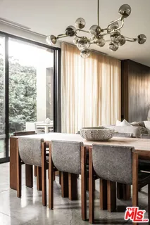 a dining table with chairs and window
