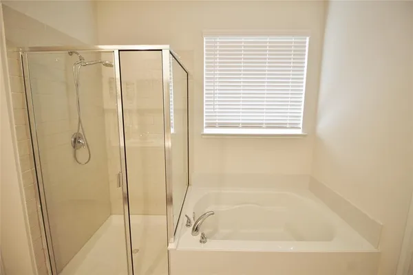 a bathroom with a shower and a bathtub