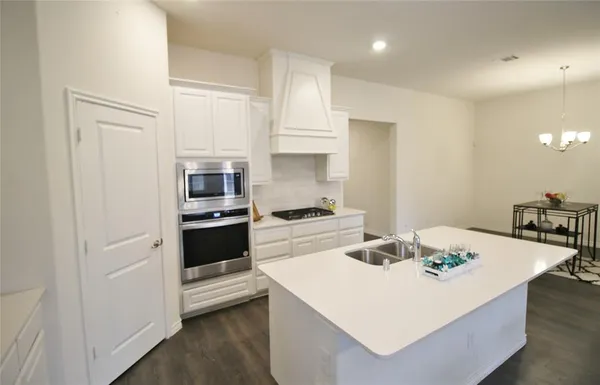 a kitchen with a sink a stove and refrigerator