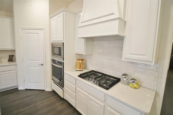 a kitchen with a stove and a refrigerator