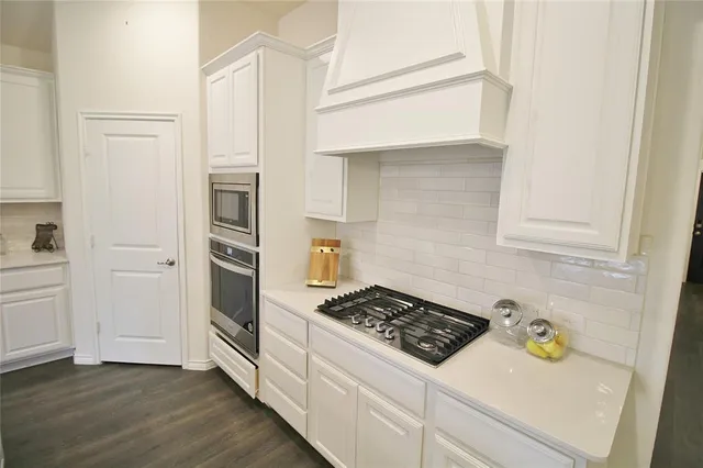 a kitchen with a stove and a refrigerator