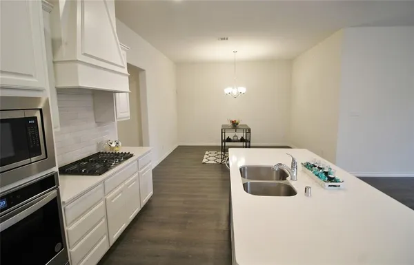 a kitchen that has a sink and a stove