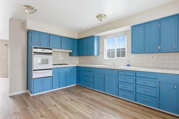 a kitchen with wooden cabinets and stainless steel appliances