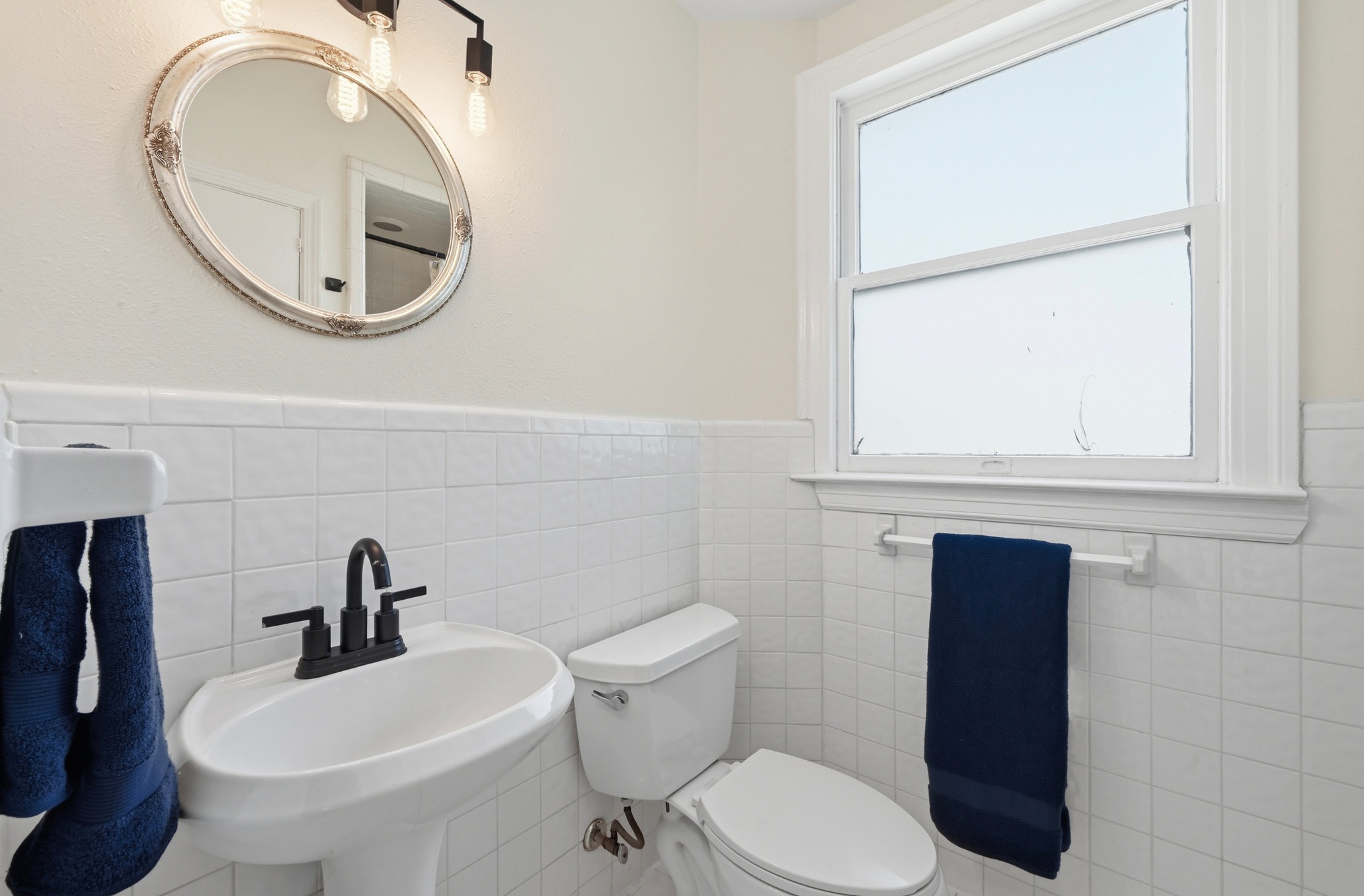 1403 Windsor Road, Unit A Austin, TX 78703 - Photo 11 of 18 a white toilet sitting next to a bathroom sink