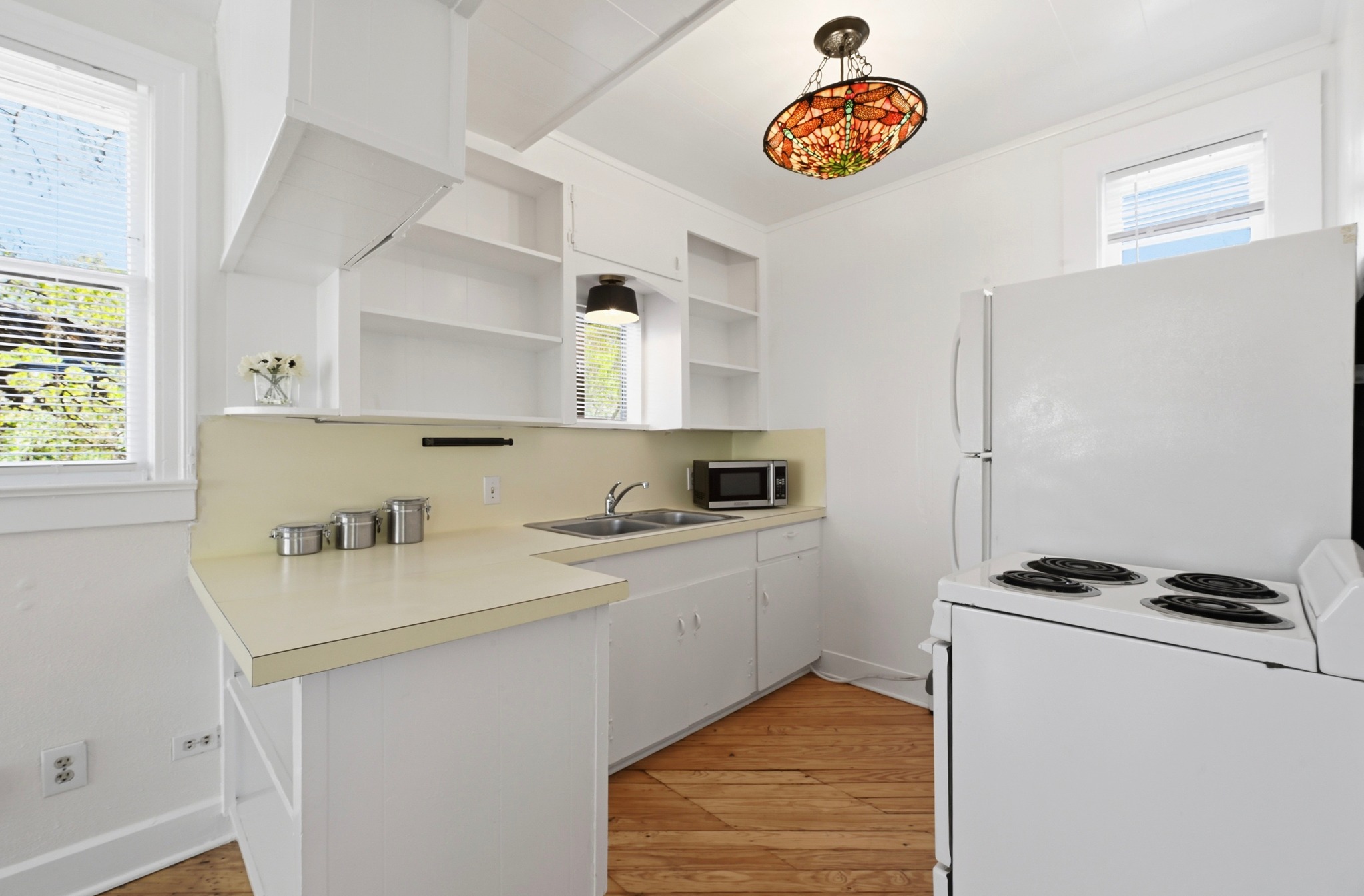 1403 Windsor Road, Unit A Austin, TX 78703 - Photo 5 of 18 a kitchen with stainless steel appliances granite countertop a sink a stove and a refrigerator