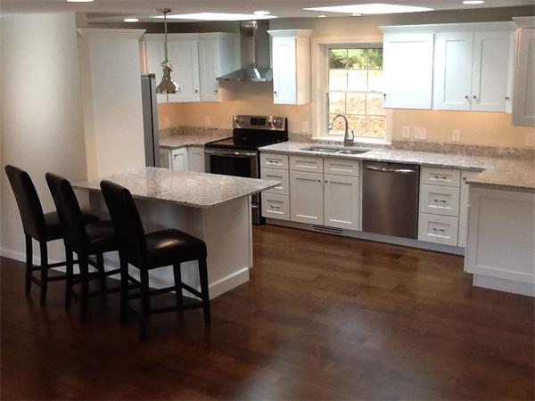 21 Meadowbrook Road Dover, MA 02030 - Photo 5 of 18 a kitchen with stainless steel appliances granite countertop a table chairs stove and sink