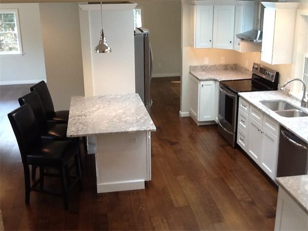 21 Meadowbrook Road Dover, MA 02030 - Photo 6 of 18 a kitchen with a table chairs sink and refrigerator