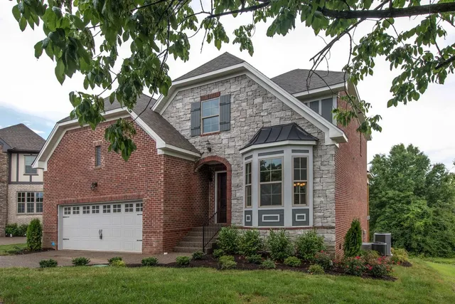 a view of a white house with a yard