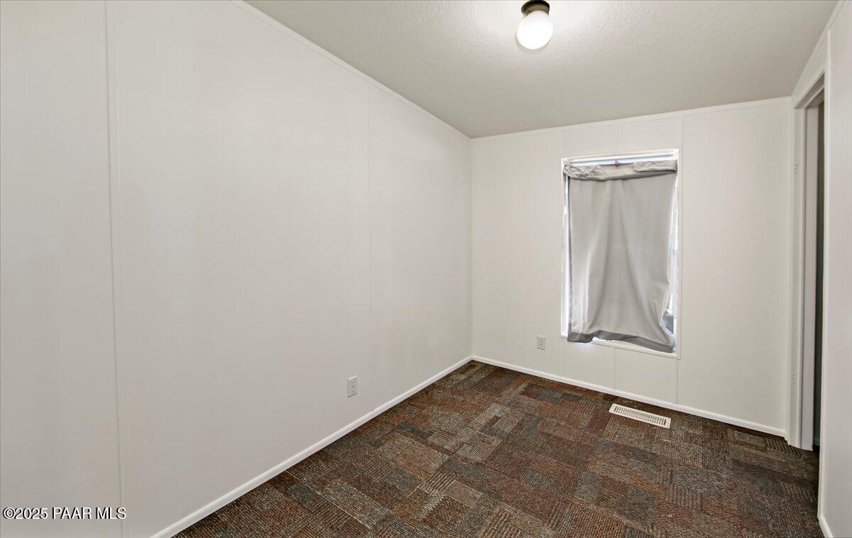 15339 South Rolling Ridge Drive Mayer, AZ 86333 - Photo 11 of 20 an empty room with wooden floor and closet