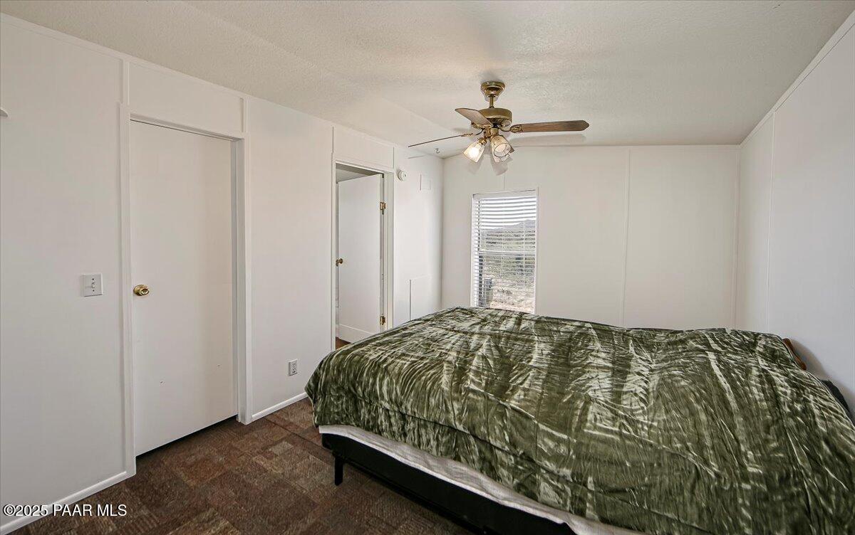 15339 South Rolling Ridge Drive Mayer, AZ 86333 - Photo 3 of 20 a bedroom with a bed and a ceiling fan