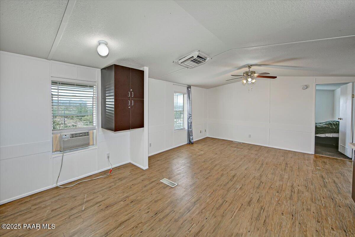 15339 South Rolling Ridge Drive Mayer, AZ 86333 - Photo 10 of 20 an empty room with wooden floor and windows