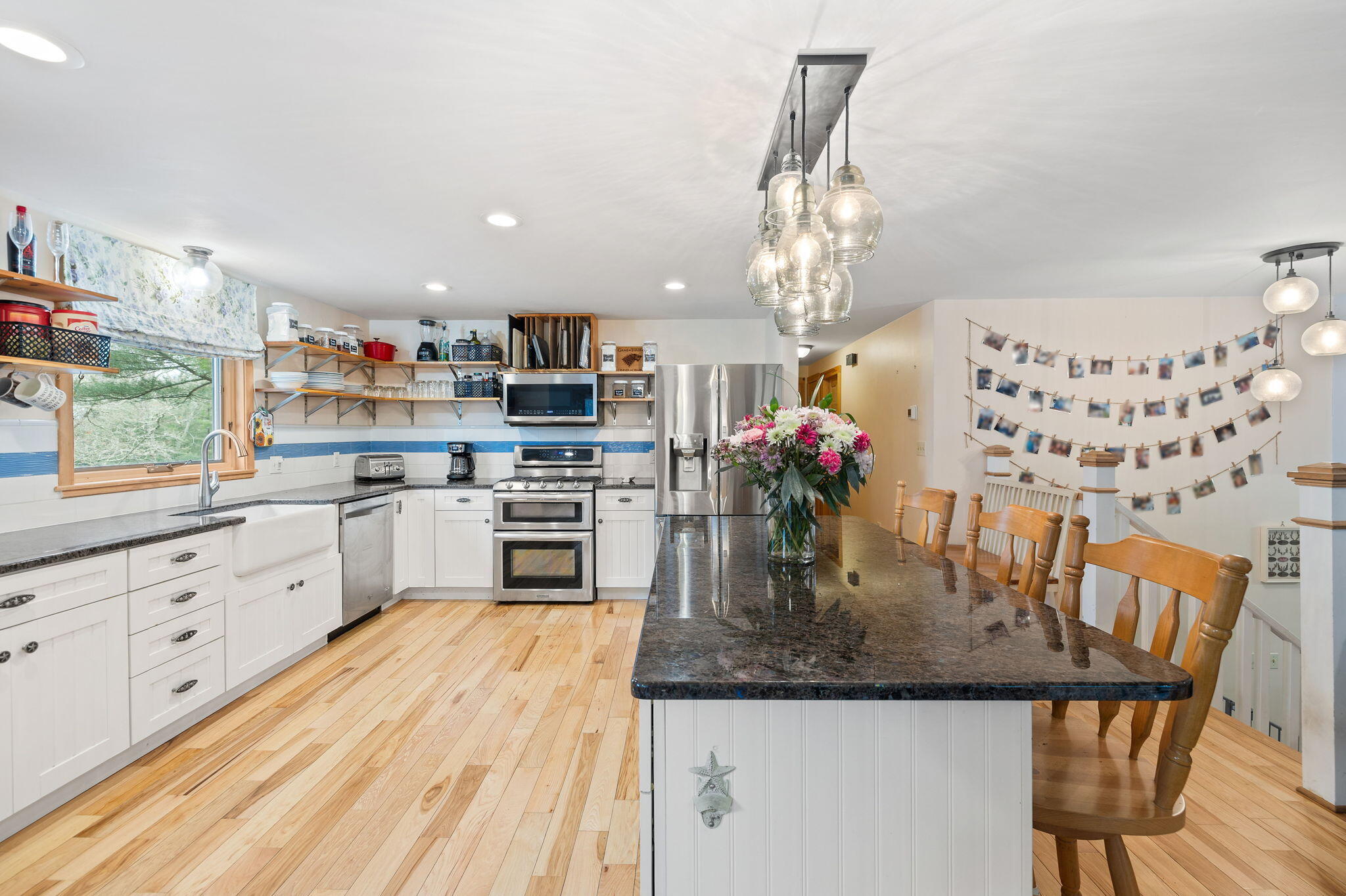 11 Michael Road Pocasset, MA 02559 - Photo 14 of 35 a kitchen with granite countertop stainless steel appliances a sink dishwasher and white cabinets with wooden floor