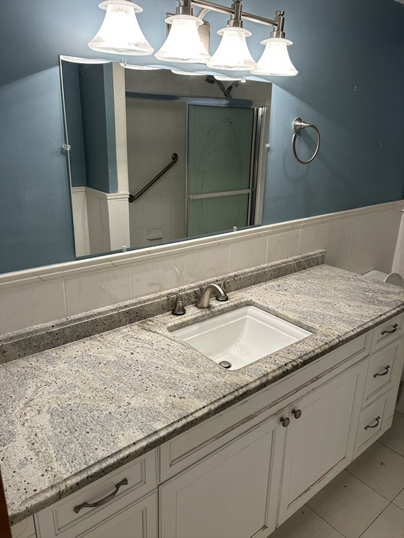 21 Athens Drive Saugus, MA 01906 - Photo 13 of 18 a bathroom with a sink and a mirror