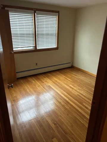 a view of a room with wooden floor and fan
