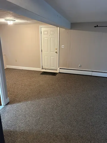 a view of a room with an empty space and a window