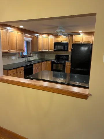 a kitchen with stainless steel appliances a refrigerator and a stove