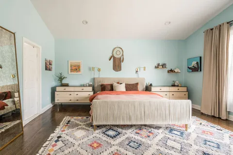 a bedroom with a bed and wooden floor