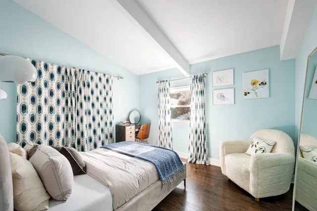 a bedroom with a bed and a window