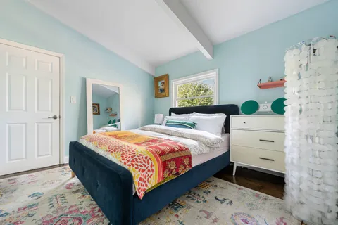 a bedroom with a bed and a window