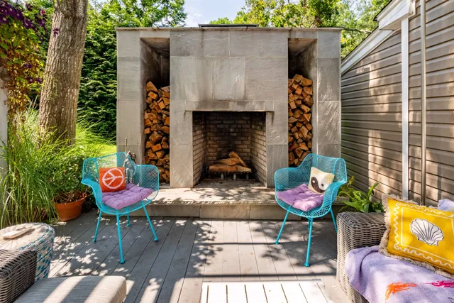 a backyard of a house with table and chairs