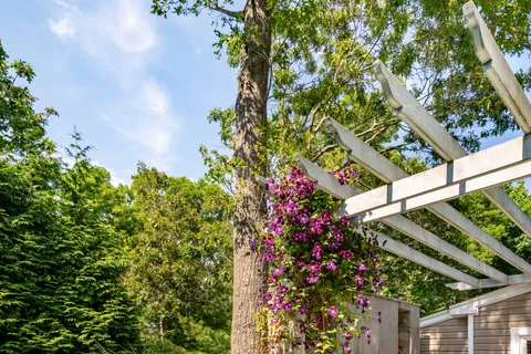 a backyard of a house with table and chairs