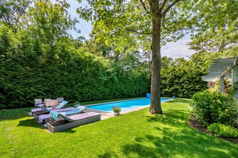 a view of yard with swimming pool and green space