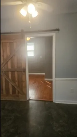 a view of room with window and hardwood floor