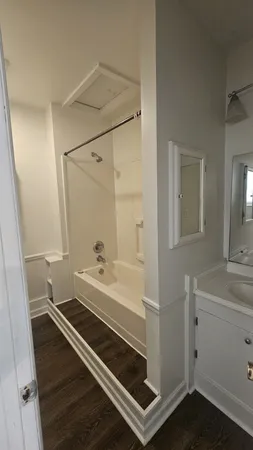a kitchen with a refrigerator sink and cabinets