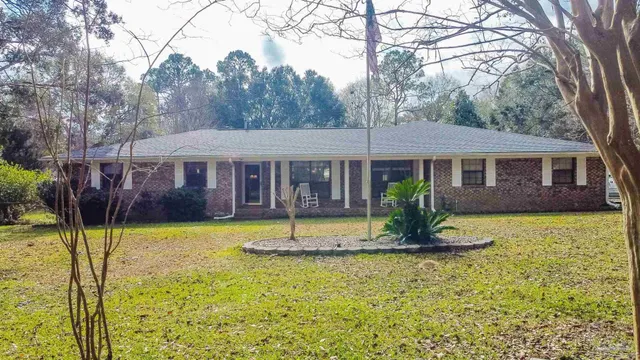 a front view of a house with a yard table and chairs