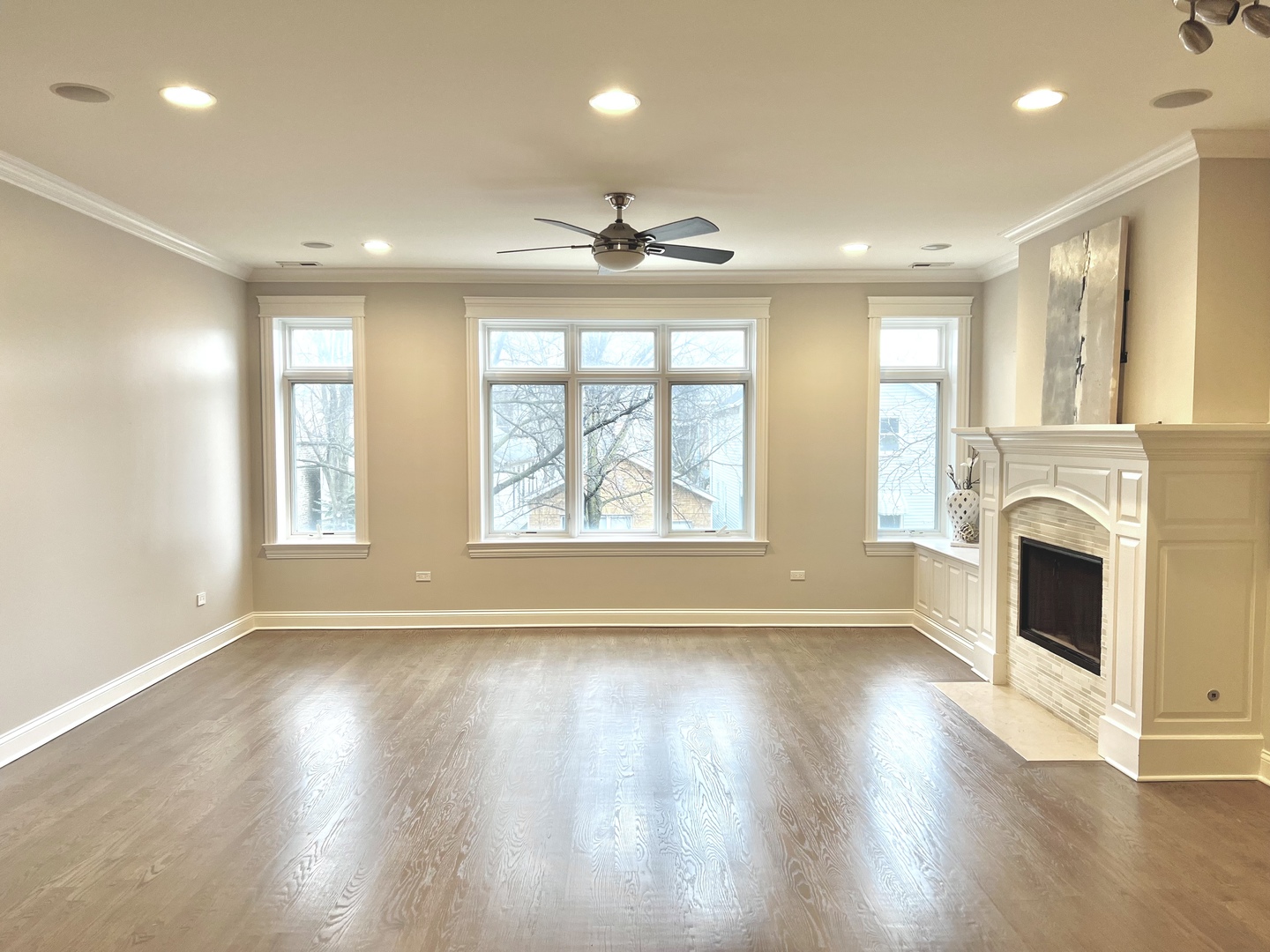 1503 West Thomas Street, Unit 2E Chicago, IL 60642 - Photo 3 of 12 a view of an empty room with wooden floor and a window