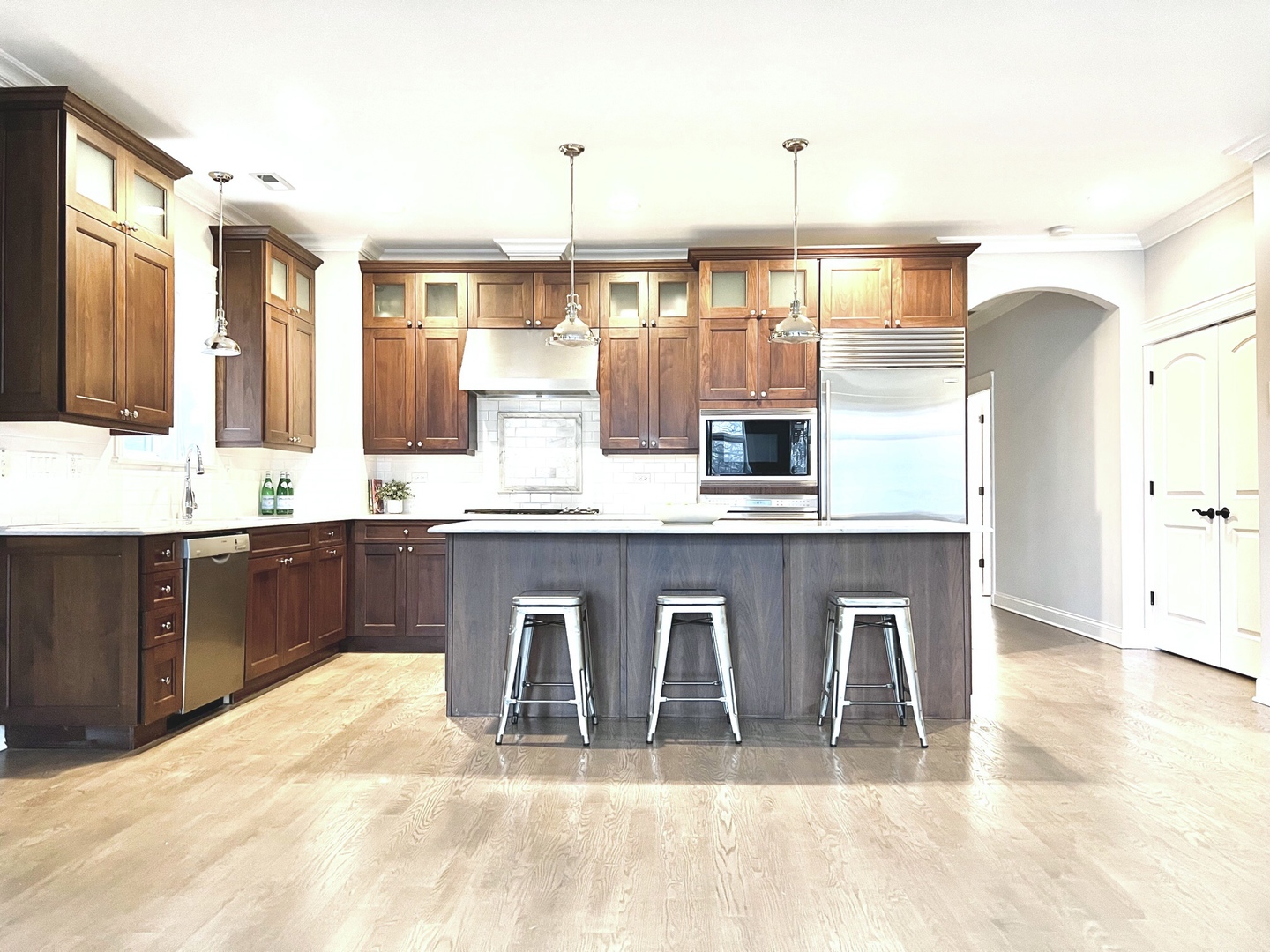 1503 West Thomas Street, Unit 2E Chicago, IL 60642 - Photo 4 of 12 a large kitchen with kitchen island a sink stainless steel appliances and cabinets
