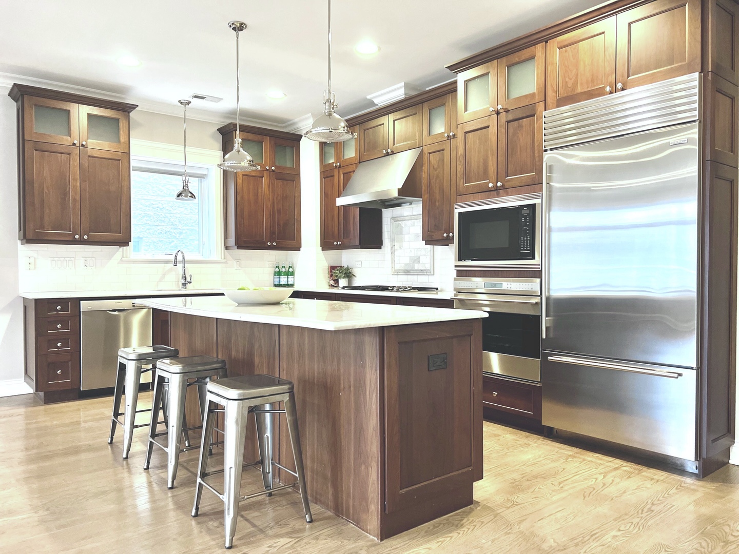 1503 West Thomas Street, Unit 2E Chicago, IL 60642 - Photo 5 of 12 a kitchen with stainless steel appliances kitchen island granite countertop a refrigerator and a stove top oven