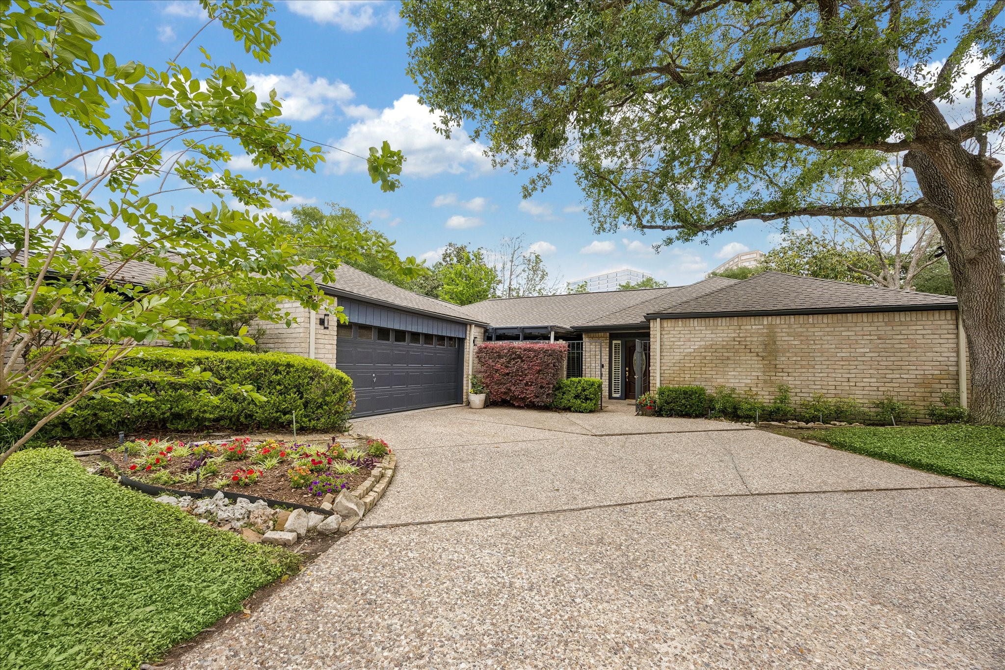 307 Oarman Court Houston, TX 77079 - Photo 1 of 38 a front view of a house with a yard and garage