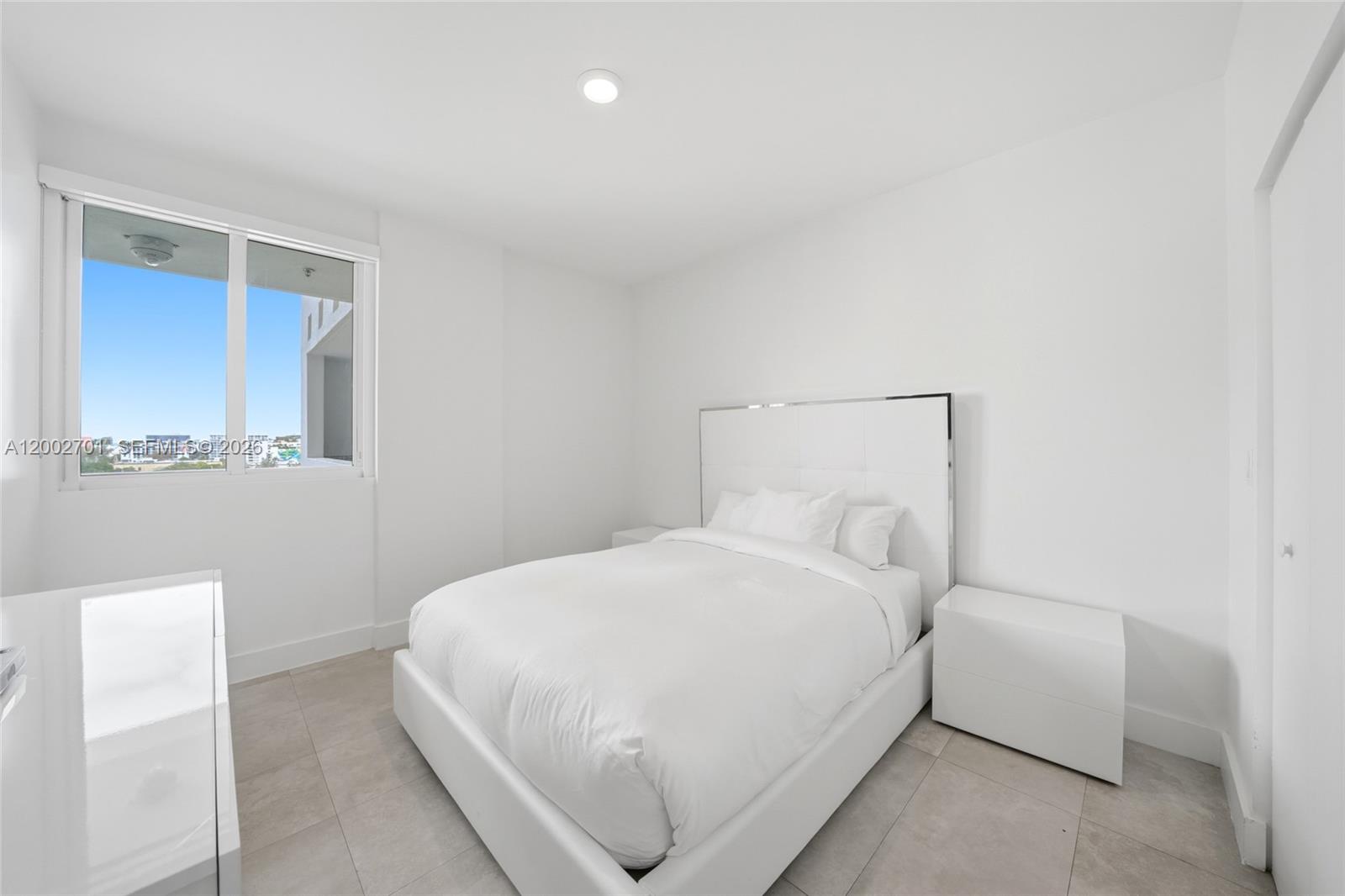 600 Northeast 27th Street, Unit 1002 Miami, FL 33137 - Photo 12 of 30 a large white bed in a white room