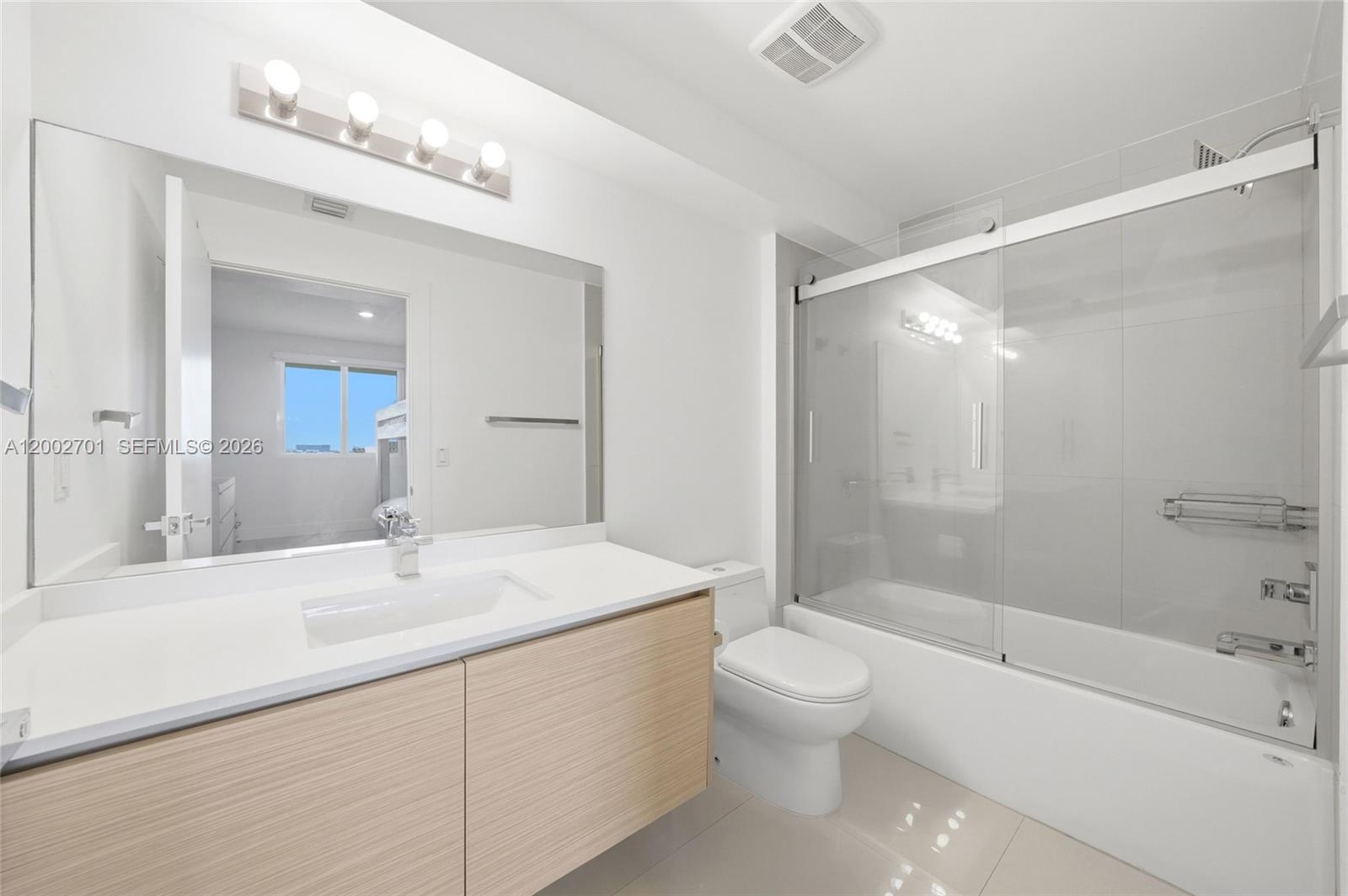 600 Northeast 27th Street, Unit 1002 Miami, FL 33137 - Photo 15 of 30 a bathroom with a sink a toilet and shower