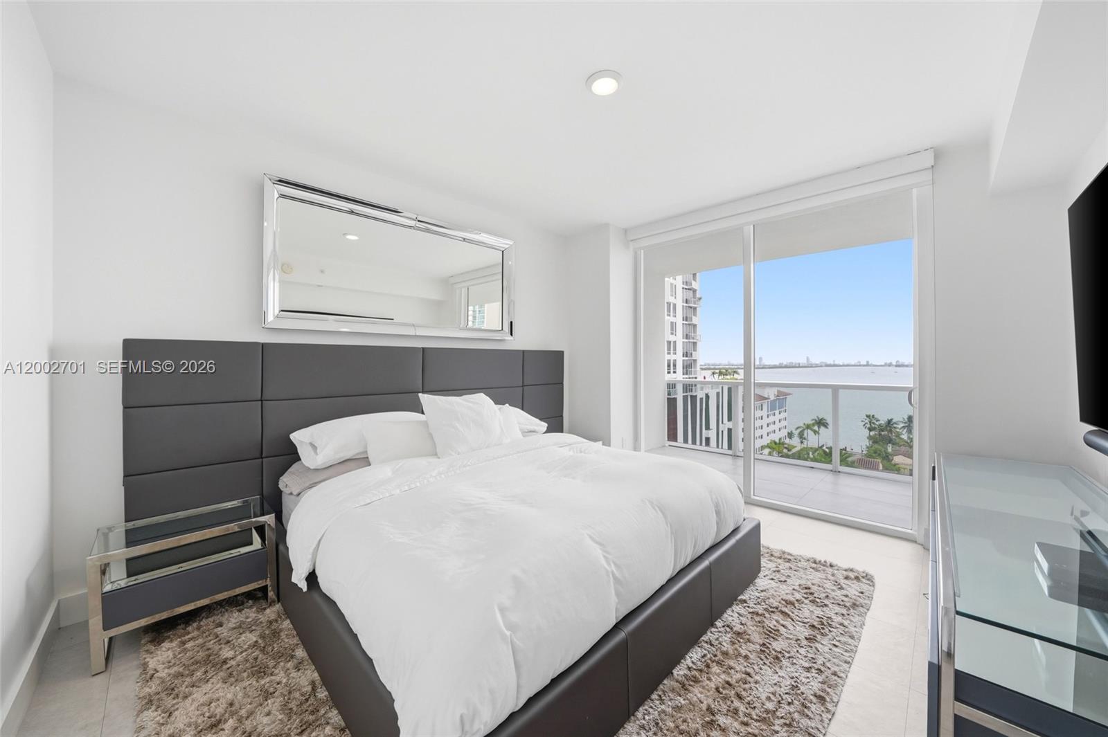 600 Northeast 27th Street, Unit 1002 Miami, FL 33137 - Photo 5 of 30 a bedroom with a bed and a window