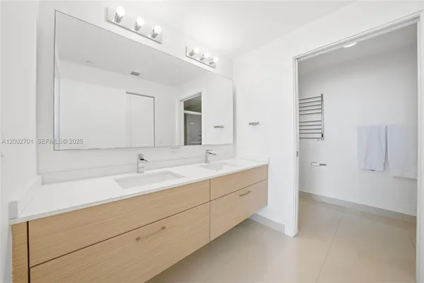 a bathroom with a double vanity sink mirror and