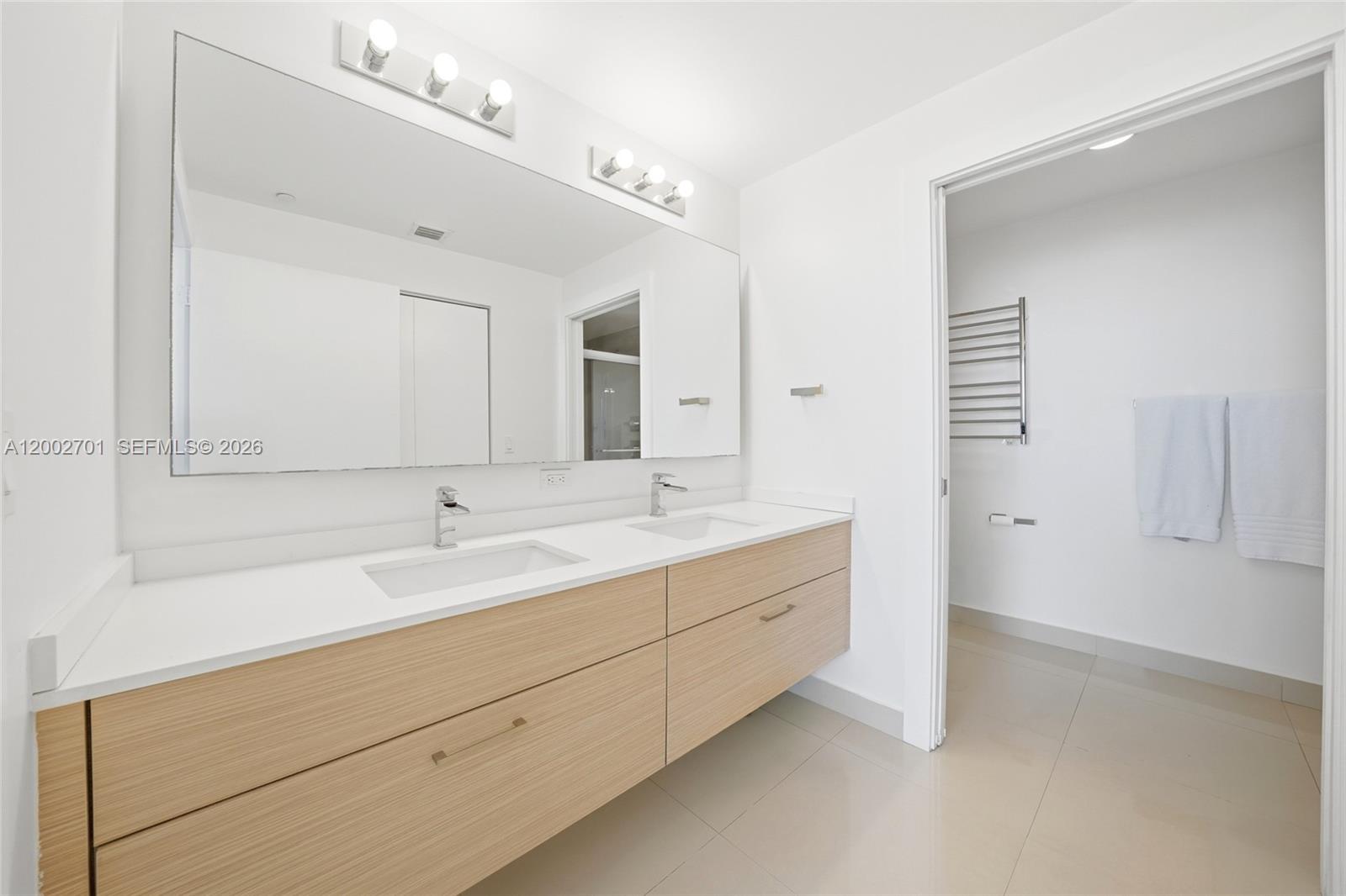 600 Northeast 27th Street, Unit 1002 Miami, FL 33137 - Photo 6 of 30 a bathroom with a double vanity sink mirror and